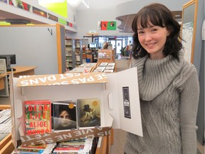 Vaudreuil-Dorion librarian Ariane Roy-Lafrance with a book club kit, which is part of the Les Soirées Pour Emporter program.