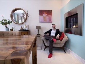 Thomas Leslie sits near the gas fireplace in the home he shares with Troy Davidson in Montreal on Monday December 18, 2017.