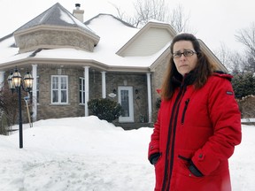 Celine Benssoussen stands in front of her  St-Lazare home in 2016. She is one of a growing list of St-Lazare homeowners whose foundations are sinking.