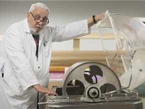 Dr. Mort Levy poses next to an Allis-Chalmers rotating drum artificial kidney machine at the MUHC's Royal Victoria Hospital on Wednesday. The stainless steel machine, a successor to the original Kolff artificial kidney, will be on display at the hospital Feb. 22 and 23 for the public. It was last used in Montreal around 1961 — and Levy tracked it down years later in the basement storage area of the Allan Memorial Institute.
