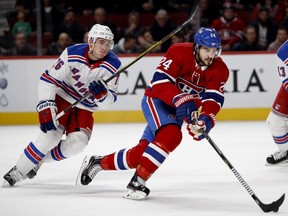 Rangers defenceman Brady Skjei fails to slow down Canadiens centre Phillip Danault dduring action Thursday night in Montreal.