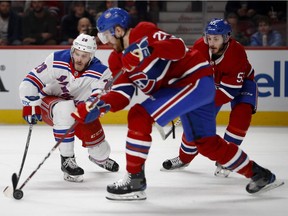 New York Rangers centre Paul Carey tries break through the Canadiens' defence pair of  Jeff Petry and rookie Victor Mete during NHL game at the Bell Centre in Montreal on Feb. 22, 2018.