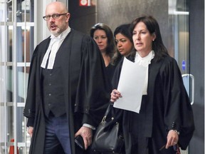 Crown prosecutors Pascal Lescarbeau and Nicole Martineau, followed by UPAC investigators, leave the Contrecoeur fraud trial for the morning break in May 2017.