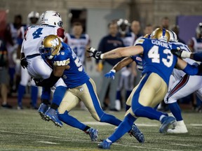 Montreal Alouettes quarterback Darian Durant is tackled by Winnipeg Blue Bombers defensive lineman Jamaal Westerman at Molson Stadium in Montreal on Aug. 24, 2017.