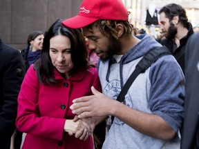 Valérie Plante listens to a man who waded into the crowd to speak to her as she took part in a march and vigil to raise awareness of the issue of homelessness in Montreal on Friday, Oct. 20, 2017.