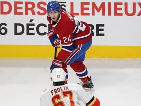 Montreal Canadiens' Phillip Danault battles Calgary Flames' Michael Frolik during on Dec. 7, 2017.