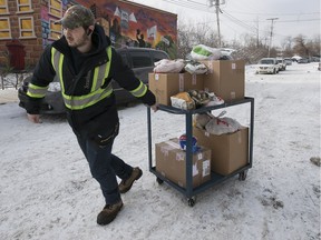 On Rock volunteer Richard Turner brings out food to waiting cars, as volunteers spread holiday cheer by delivering nearly 300 Christmas baskets in December.