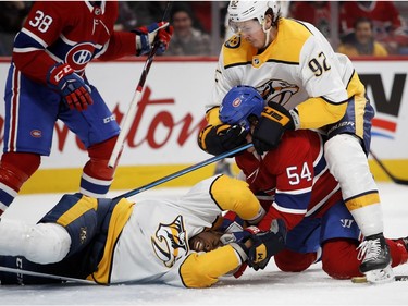 Nashville Predators center Ryan Johansen pulls Montreal Canadiens left wing Charles Hudon off Nashville Predators defenseman P.K. Subban's after Hudon pushed his head in to the ice after Subban fell over him and dragged Hudon to the ice during HNL action in Montreal Saturday February 10, 2018.