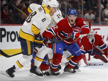 Montreal Canadiens center Byron Froese and Nashville Predators center Kyle Turris both let out a scream as they chase the puck into the corner during HNL action in Montreal Saturday February 10, 2018.