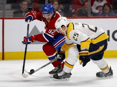 Montreal Canadiens center Jonathan Drouin and Nashville Predators defenseman Alexei Emelin battle for control of the puck during HNL action in Montreal Saturday February 10, 2018.