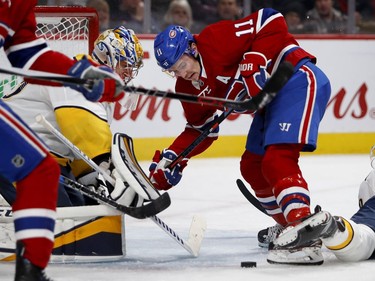 Montreal Canadiens right wing Brendan Gallagher tries to get a skate on the puck as Nashville Predators goaltender Pekka Rinne leans out to knock it away during HNL action in Montreal Saturday February 10, 2018.