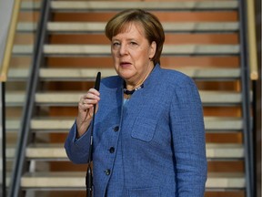 German Chancellor Angela Merkel gives a statement as she arives at the Social Democrats Party (SPD) headquarters on Feb. 4, 2018 in Berlin, as German Conservatives (CDU/CSU) and Social Democrats hope to complete negotiations to form a government.