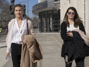 Tennis star Eugenie Bouchard, left, leaves Brooklyn Federal court with her mother, Wednesday, Feb. 21, 2018, in New York. Bouchard testified during her negligence lawsuit against the United States Tennis Association that a wet floor caused her to slip and fall inside a locker room at the 2015 U.S. Open.