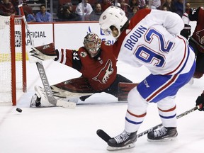 Arizona Coyotes goaltender Antti Raanta (32) makes a save on a shot by Montreal Canadiens center Jonathan Drouin (92) during the second period of an NHL hockey game Thursday, Feb. 15, 2018, in Glendale, Ariz.