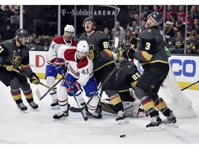 Vegas Golden Knights' William Karlsson (71), defenceman Nate Schmidt (88), goaltender Marc-André Fleury (29) and defenceman Brayden McNabb (3) defend the goal against Canadiens' Tomas Plekanec (14) and left wing Paul Byron  on Saturday, Feb. 17, 2018, in Las Vegas.