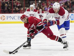 Carolina Hurricanes' Derek Ryan (7) and Montreal Canadiens' Nicolas Deslauriers (20) fight for the puck during the first period of an NHL hockey game in Raleigh, N.C., Thursday, Feb. 1, 2018.