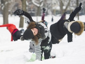 Melissa Ciampanelli, front, participates in an outdoor yoga session at Lafontaine Park in Montreal on Saturday, Feb. 10, 2018.