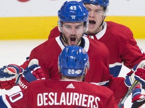 Canadiens' Logan Shaw (49) celebrates with teammate Nicolas Deslauriers (20) after scoring against the Anaheim Ducks in Montreal on Saturday, Feb. 3, 2018.