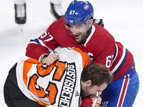 Canadiens captain Max Pacioretty mixes it up with Philadelphia Flyers defenceman Shayne Gostisbehere during first period of NHL game at the Bell Centre on Feb. 26, 2018. Both players received two-minute penalties for roughing.