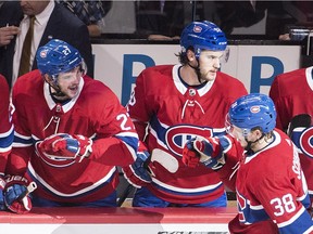 Canadiens' Nikita Scherbak, right, celebrates with teammates Alex Galchenyuk, left, and Jonathan Drouin after scoring against the New York Islanders Wednesday night at the Bell Centre.