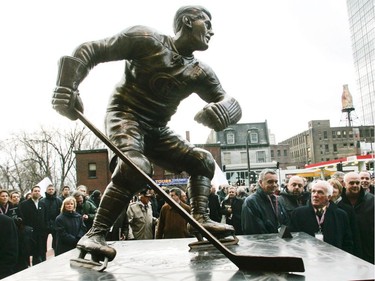 Henri Richard (right) looks up at a sculpture of his late older brother Maurice (Rocket) Richard at the inauguration of the Canadiens Centennial Plaza on Dec. 4, 2008 outside the Bell Centre.