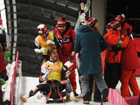 Canada's Tristan Walker and Justin Snith celebrate after finishing the final leg of the luge team relay at the Pyeongchang Olympics on Feb. 15.