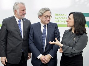 Caisse CEO Michael Sabia, centre, is flanked by Quebec Premier Philippe Couillard and Montreal Mayor Valérie Plante following news conference in Montreal, Thusday, Feb. 8, 2018, where they announced details of new automated light-rail system for the Montreal region.