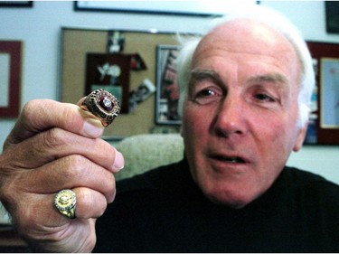 Henri Richard displays one of his Stanley Cup rings in Montreal in 2000.