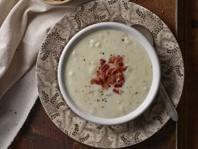 Herbed Potato Soup is topped with crisp-cooked bacon in this recipe from Rose Murray's Comfortable Kitchen Cookbook.