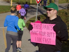 Scott Palmer of London, Ont., had some fun with signs to encourage his wife, Laura, in this marathon in 2013.