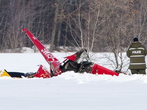 Investigators look over the scene of a helicopter crash that killed three people on board in Drummondville on Friday, February 2, 2018.
