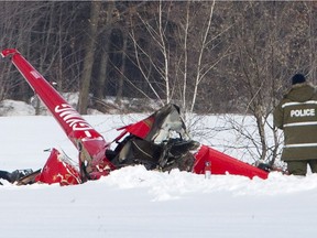 Investigators look over the scene of a helicopter crash that killed three people on board in Drummondville, Que., on Friday, February 2, 2018.
