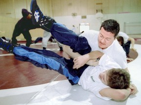 Kahnawake Survival School wrestling coach Dave Canadian pins student Kyle Martin during a workout in 1995.