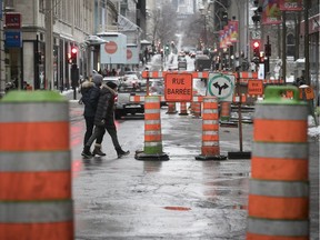 The Montreal reality: Pedestrians dodge roadwork signs and traffic cones downtown in January.