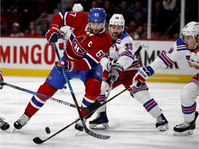 Montreal Canadiens left wing Max Pacioretty is crowded by New York Rangers centre Kevin Hayes, left to right, New York Rangers right wing Mats Zuccarello and New York Rangers defenceman Brady Skjei during NHL action in Montreal Thursday February 22, 2018.