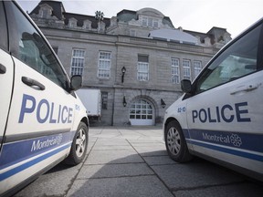 Police vehicles are seen parked outside Montreal city hall.