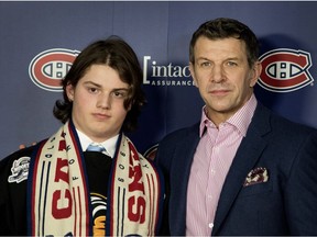 AAA Lions forward Justin Hryckowian receives an athletic bursary from Marc Bergevin of the Montreal Canadiens in Montreal last Wednesday.