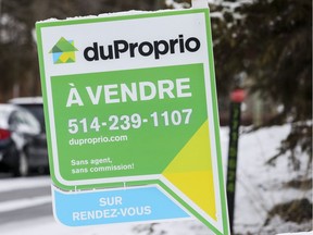 A DuProprio for sale sign on the lawn of a home in Lachine on Monday.