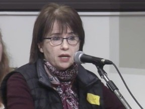 Ginette Chartre, wearing a yellow badge, addresses an Outremont borough council meeting on Monday, March 5, 2018.