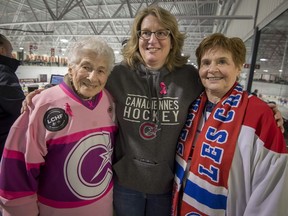 Irene Durdon, left, Lana Lloyd and Nancy Durdon cheer on Les Canadiennes at the Bell Sports Complex, in Brossard on Sunday.