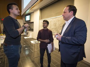 Antonio Bramante, right, a cannabis business expert, speaks with students Mushfiq Kamal, left, and Seyon Sounthararaja, right, at The Weed Conference in Montreal on Saturday, March 10, 2018.