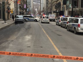 Police on the scene after a man was shot in the Giorgio Gruppo Roma boutique on Peel St. on Monday, March 12, 2018.