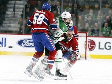 Montreal Canadiens Noah Juulsen check Dallas Stars Alexander Radulov as Habs Karl Alzner watches during first period of National Hockey League game in Montreal Tuesday March 13, 2018.