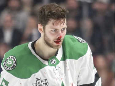 Dallas Stars Jason Dickinson heads off the ice with a bloody nose following fight with Montreal Canadiens Nicolas Deslauriers during third period of National Hockey League game in Montreal Tuesday March 13, 2018.