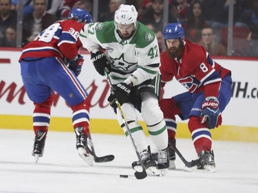 Dallas Stars Alexander Radulov spins away from Montreal Canadiens Jordie Benn, right, and Nikita Scherbak during first period of National Hockey League game in Montreal Tuesday March 13, 2018.