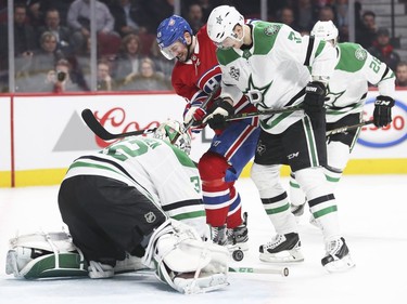 Montreal Canadiens Logan Shaw can't get to loose puck in front of Dallas Stars goalie Kari Lehtonen while being checked by defenceman John Klingberg during first period of National Hockey League game in Montreal Tuesday March 13, 2018.
