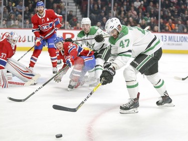 Dallas Stars Alexander Radulov tries to control rolling puck as teammate Devin Shore heads to the Montreal Canadiens net defended by goalie Antti Niemi, Jeff Petry and Byron Froese during second period of National Hockey League game in Montreal Tuesday March 13, 2018.