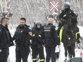 Montreal police officers, including members of the cavalry unit, take part in the search for Ariel Jeffrey Kouakou on Wednesday March 14, 2018.