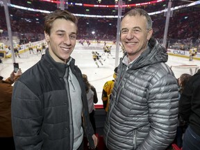 Guillaume Ouimet watches the Pittsburgh Penguins warm up with his father Guy prior to their game against the Canadiens at the Bell Centre on Thursday.