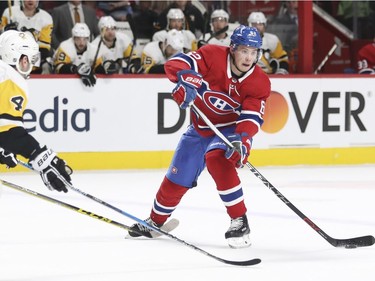 Montreal Canadiens Artturi Lehkonen is defended by Pittsburgh Penguins Justin Schultz during first period of National Hockey League game in Montreal, Thursday March 15, 2018.